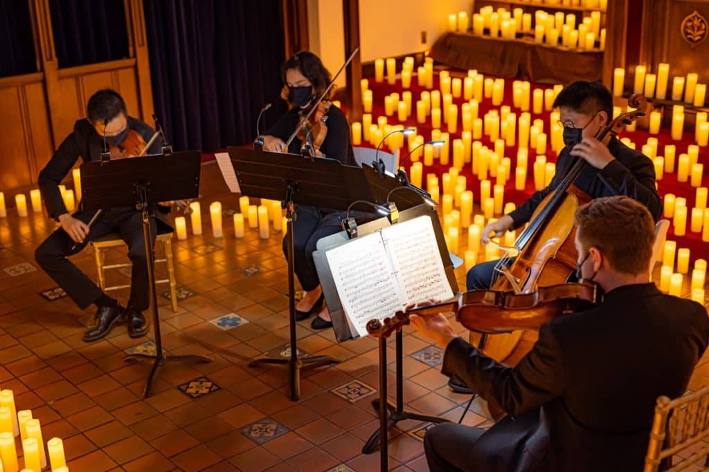 Musicians playing by candlelight