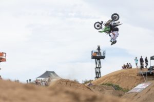 A motocross rider flips through the air